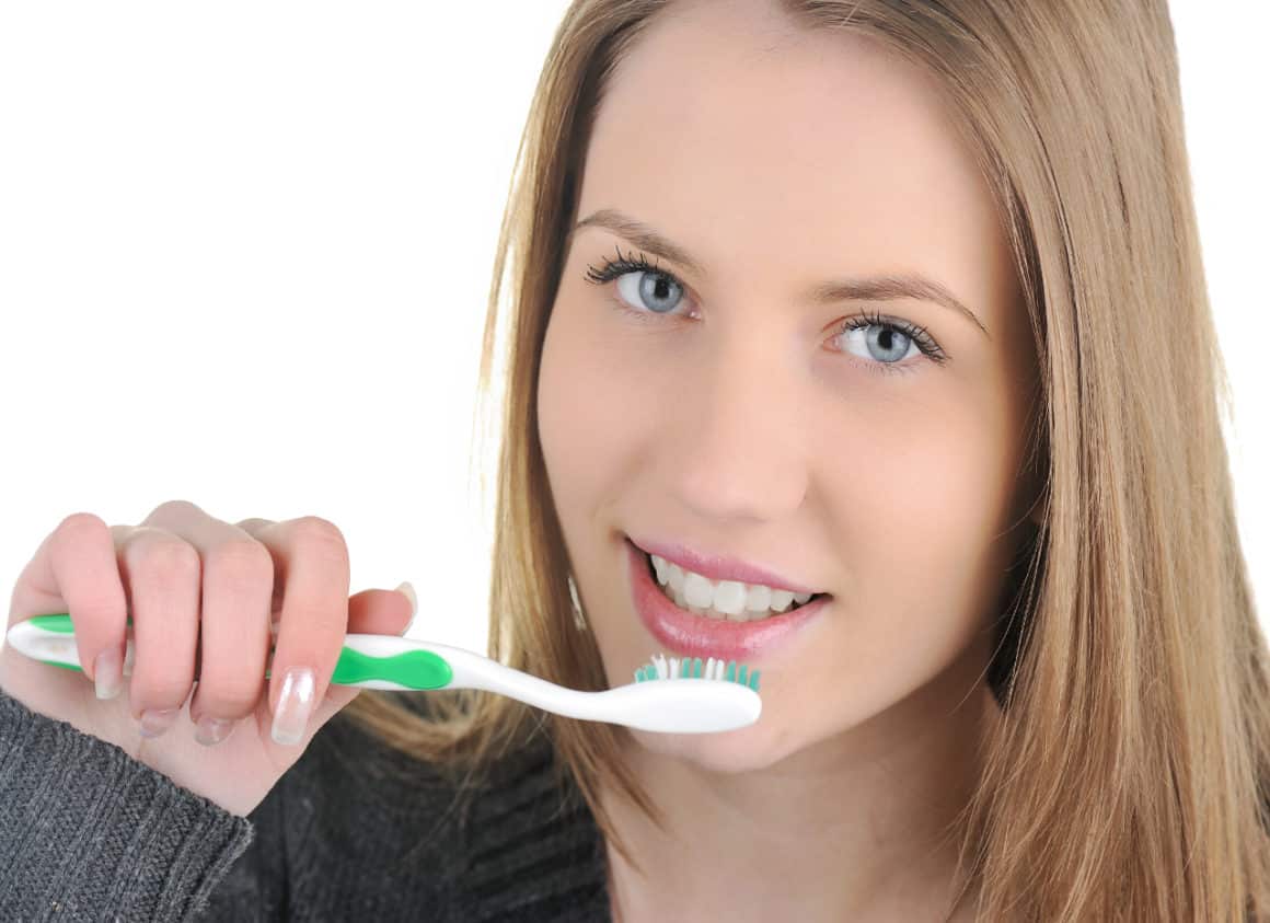 woman brushing her teeth