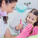 dentist with little girl patient
