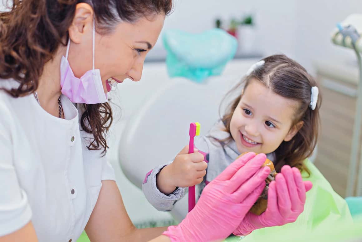 dentist with little girl patient