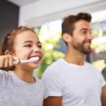 dad and daughter brushing their teeth