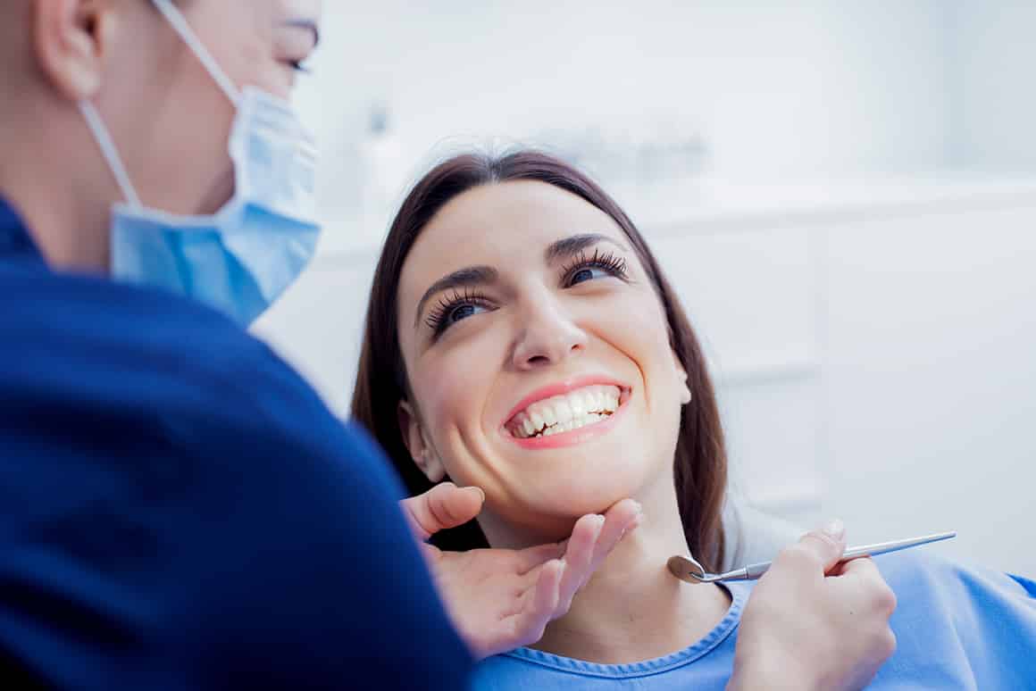 woman smiling in the dentist chair