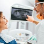 dentist showing patient her xrays