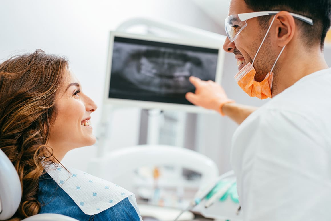 dentist showing patient her xrays