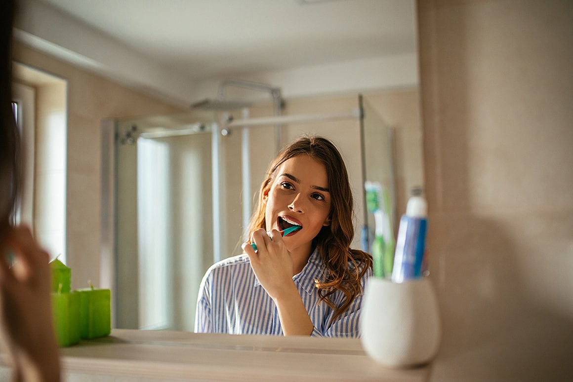 woman brushing her teeth