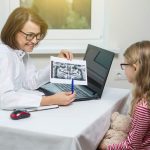 dentist showing little girl her xray at the dentist